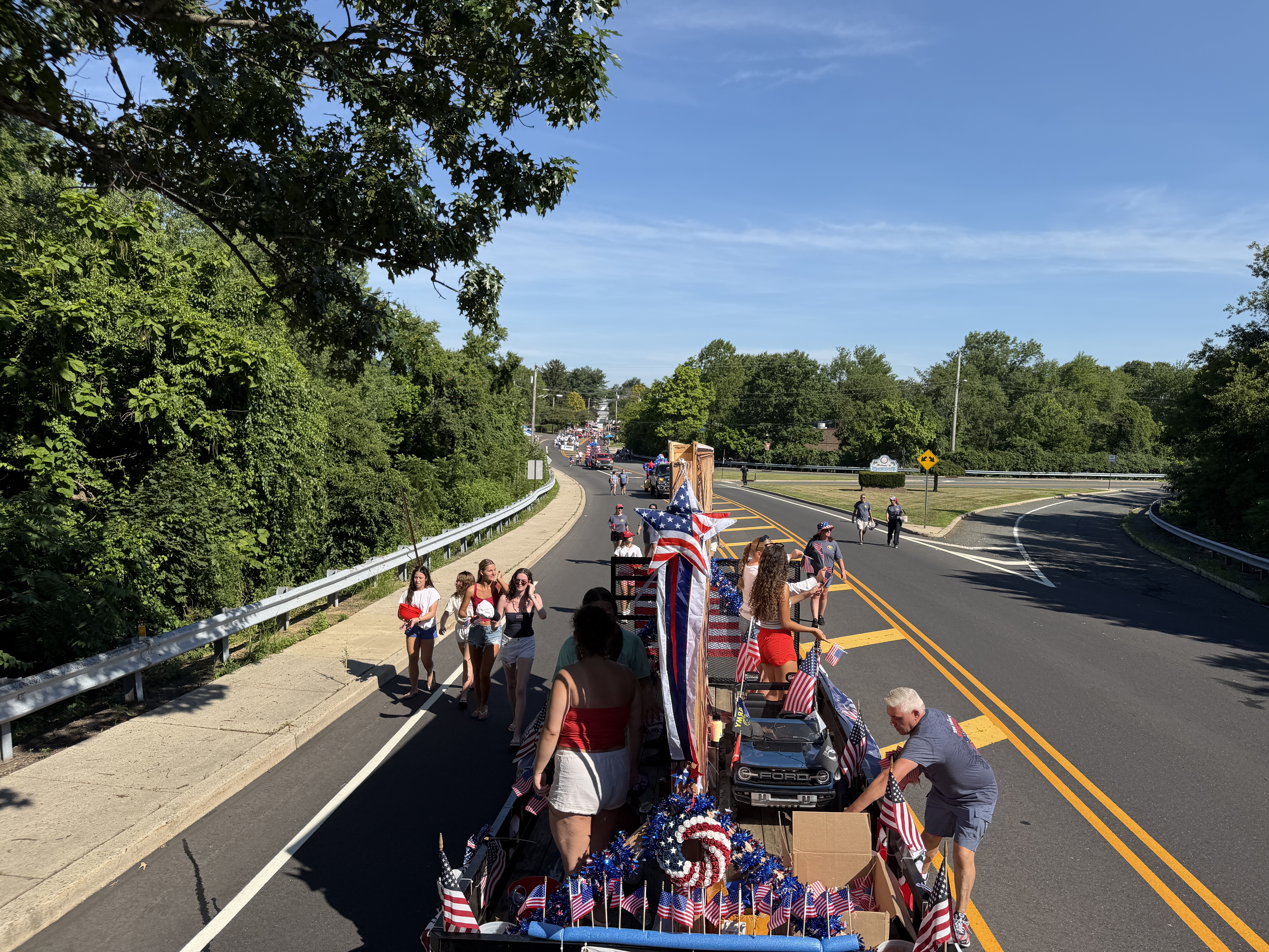 The Berlin NJ July 4th 2026 parade stretches into the distance — floats, marchers, and American flags as far as the eye can see