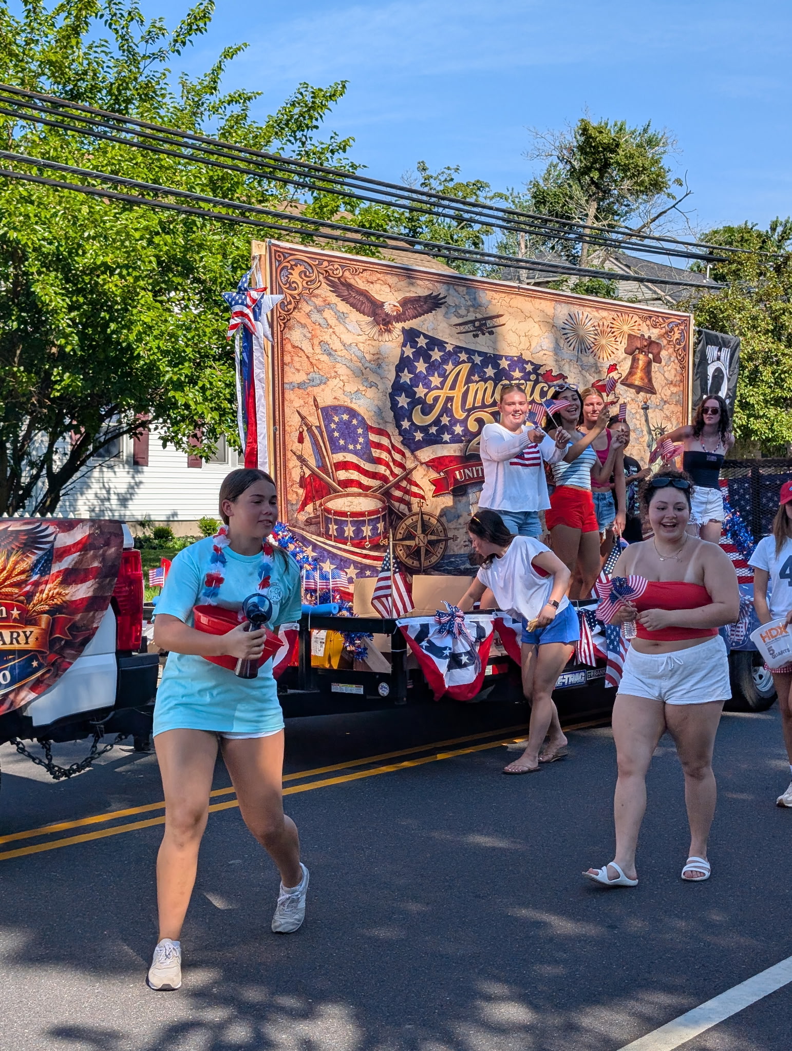 Float walkers celebrate alongside the America 250 banner in Berlin NJ's July 4th 2026 parade