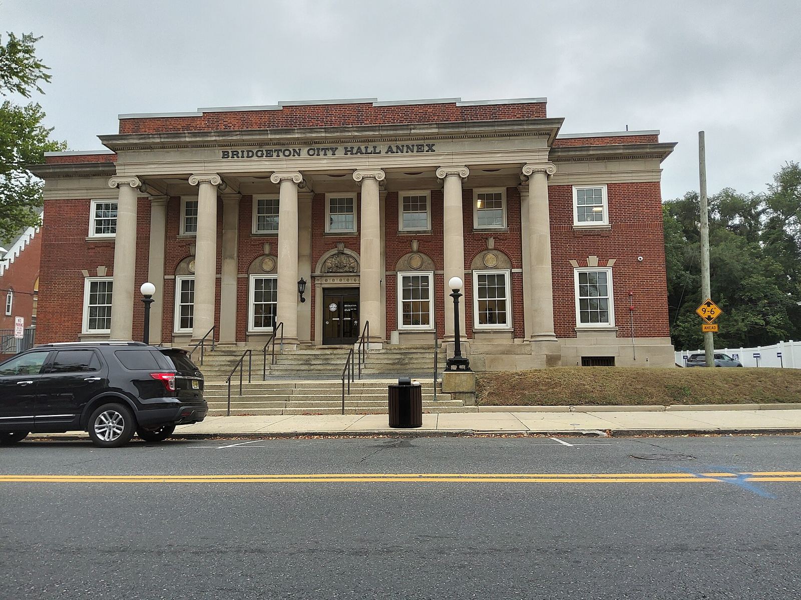 A two-story red brick building with six stone columns and the words Bridgeton City Hall Annex above the entrance