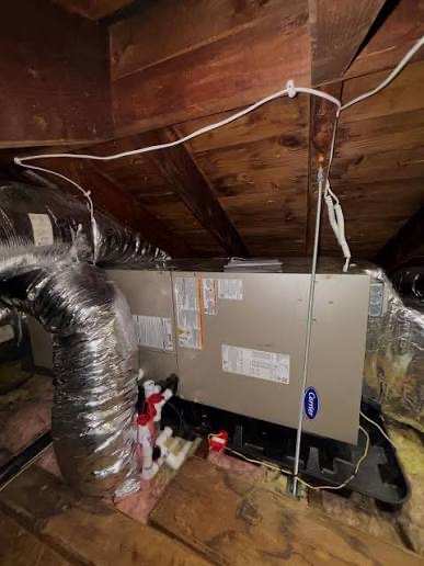 A residential Carrier air handler unit installed in an attic — the kind of equipment Clean Air Maintenance services across South Jersey