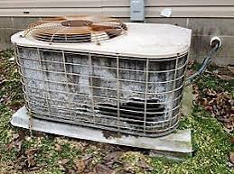 A heavily neglected outdoor AC condenser unit — clogged, corroded, and overworked