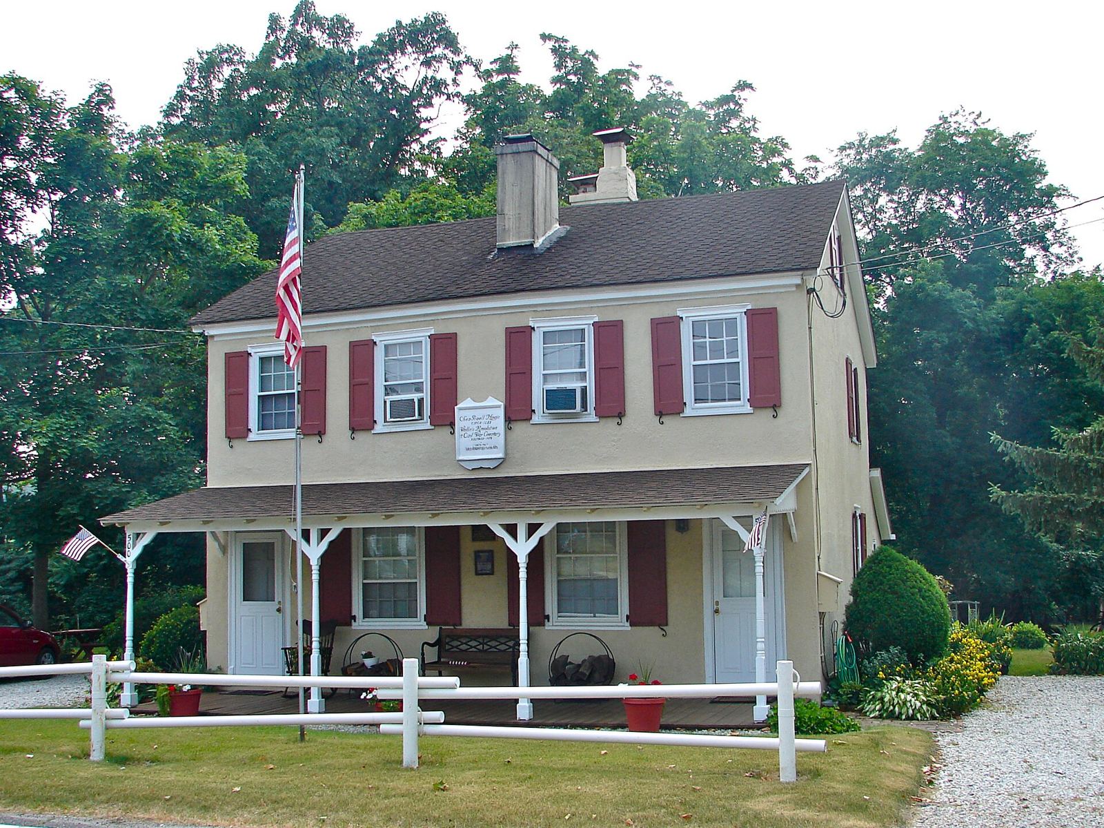The two-story Chew-Powell House with red shutters and a front porch on Good Intent Road
