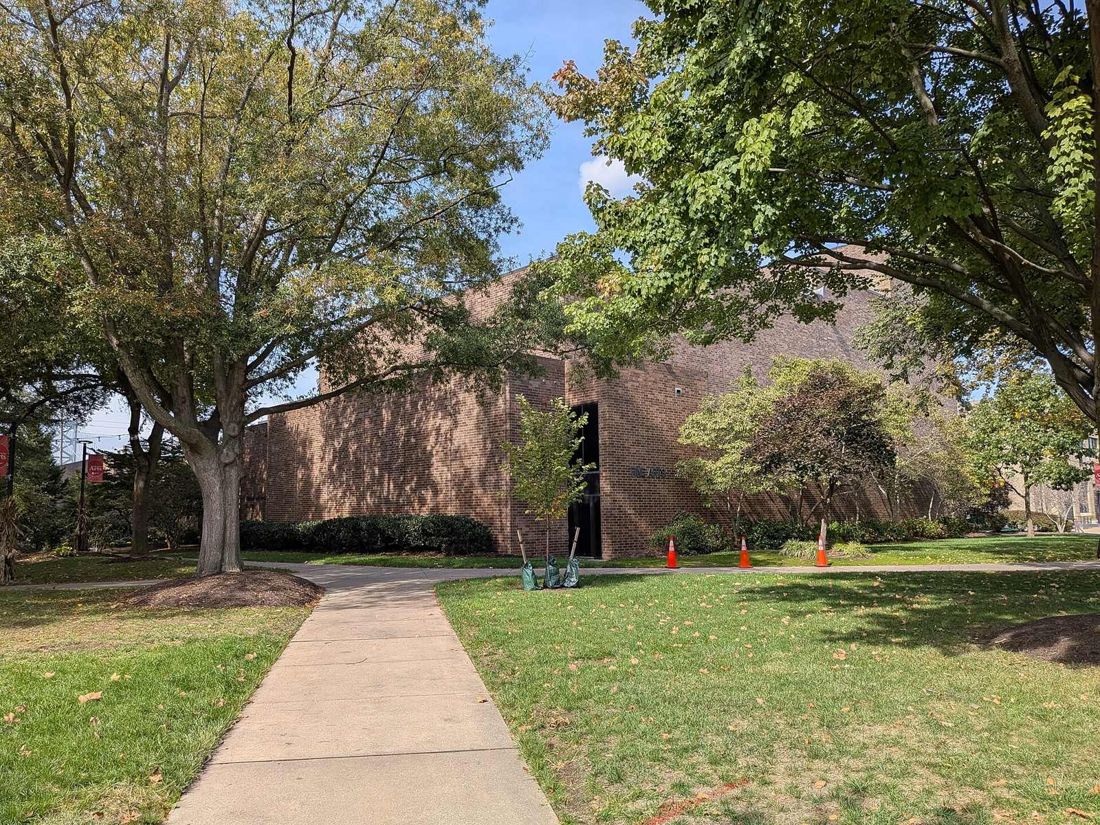 The brick Fine Arts Building on the Rutgers-Camden campus, framed by trees and a walkway