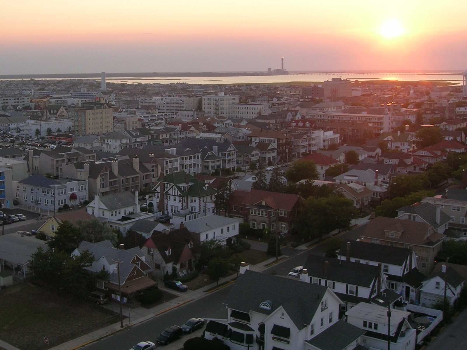 Ocean City rooftops at sunset, seen from above, with the bay behind them