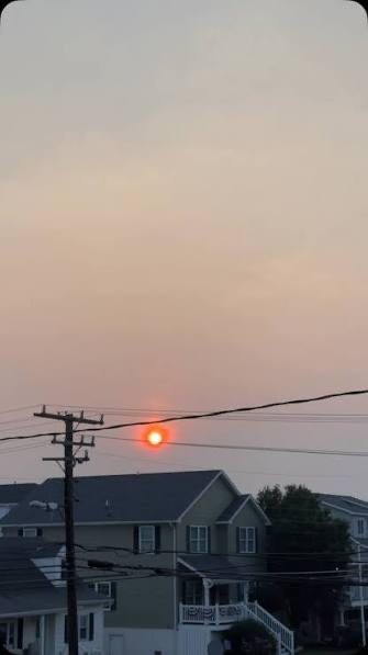 Wildfire smoke turns the sun red over a South Jersey shore town this week