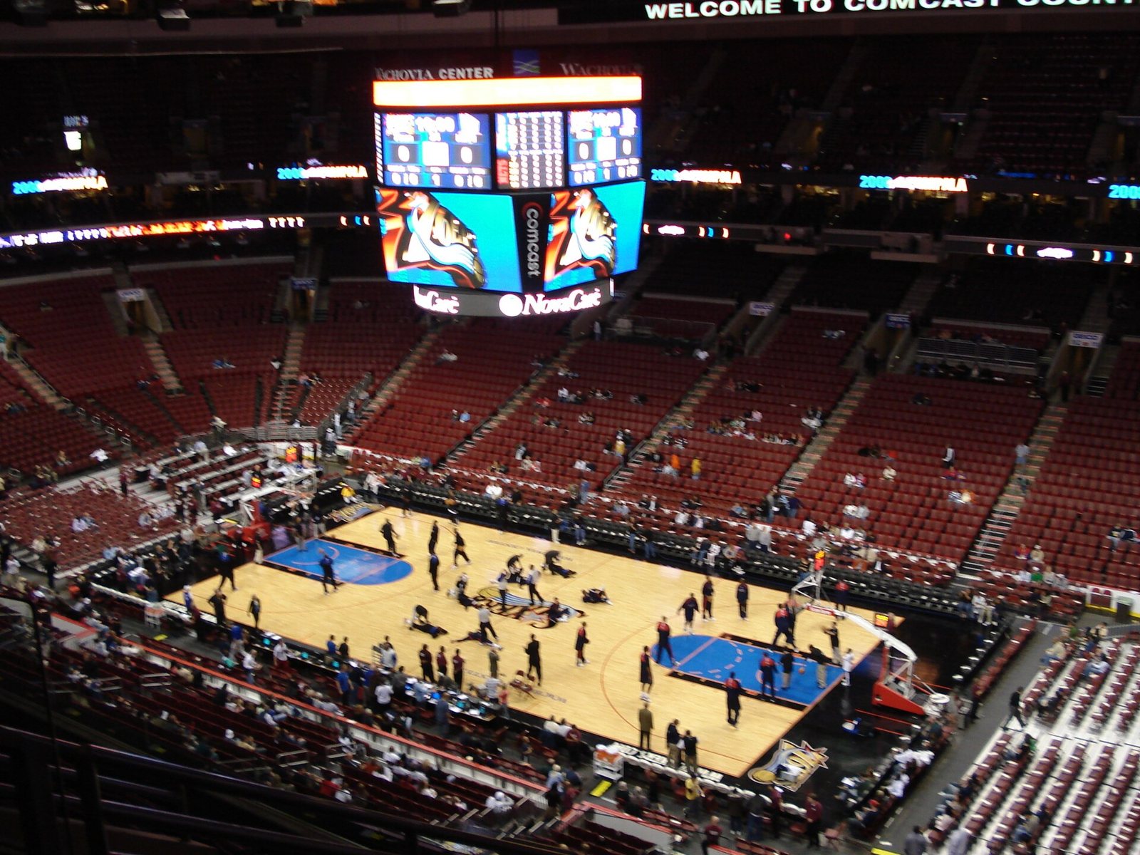 The 76ers' arena in South Philadelphia seen from the upper deck, with players warming up on the court before a game