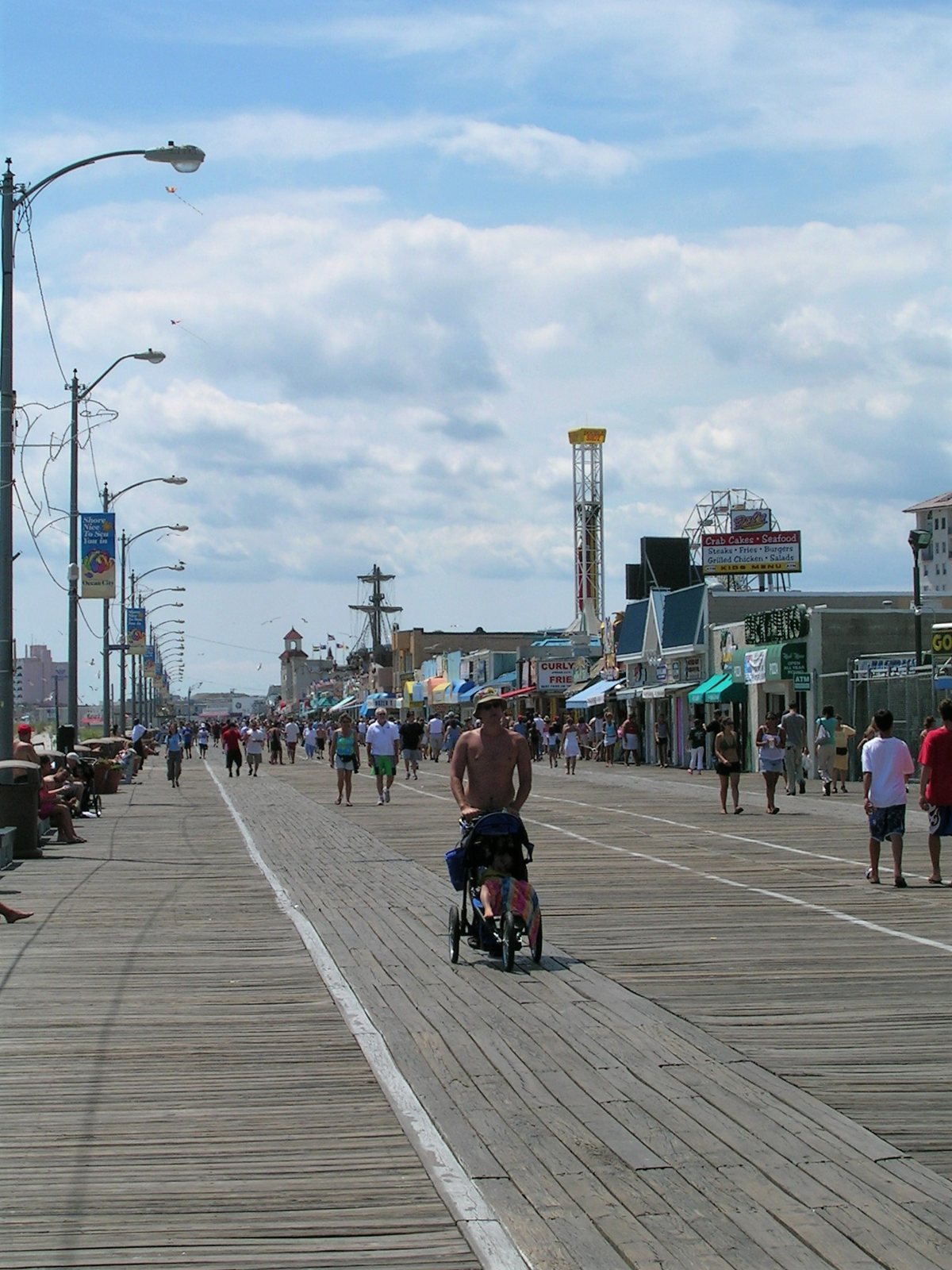 Walkers on the Ocean City boardwalk on a sunny day